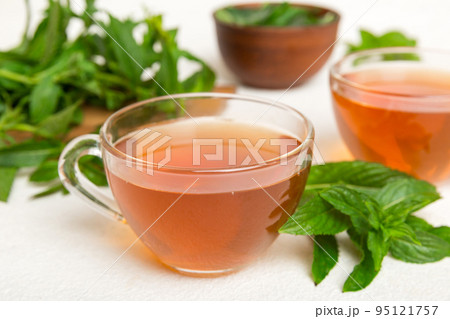 Cup of mint tea on table background. Green tea with fresh mint top view with copy space 95121757
