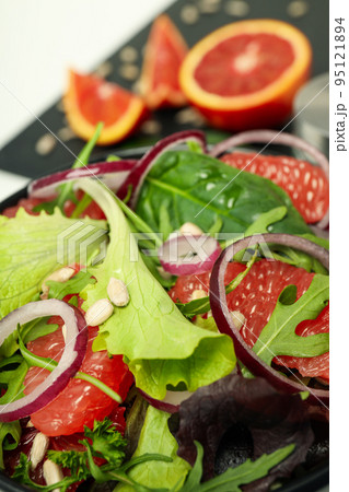 Concept of tasty food, salad with red orange, close up Concept of tasty food, salad with red orange, close up 95121894