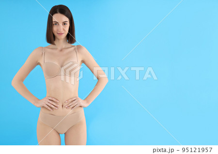 Concept of weight loss, young woman on blue background 95121957