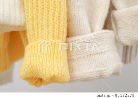 Sweaters hang on hangers, close up and selective focus 95122579