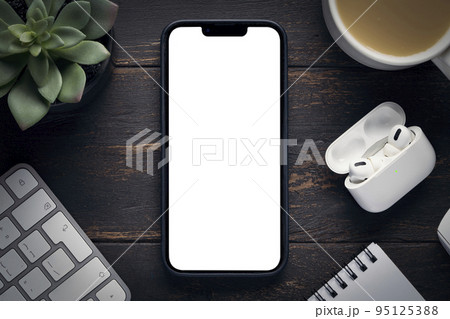 the new iPhone 14 pro max with an empty white screen copy space mockup, an office space on the desktop and a coffee mug Krasnoyarsk, Russia, 2022 10 01 95125388