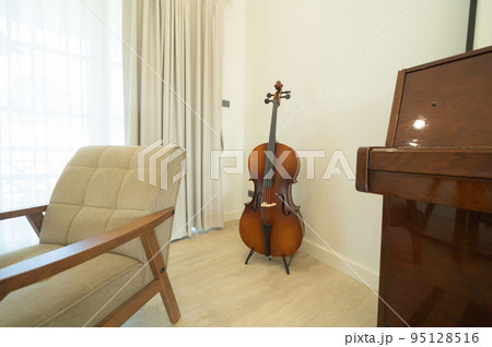 Piano and cello room at home or house for party music performance. Interior design. Entertainment. Celebration event. People lifestyle. Pianist hobby. 95128516