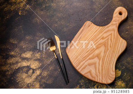 An empty brown ceramic plate on a dark concrete brown background 95128985