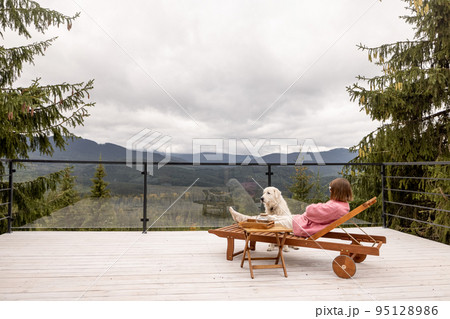 Woman rests on terrace in mountains 95128986