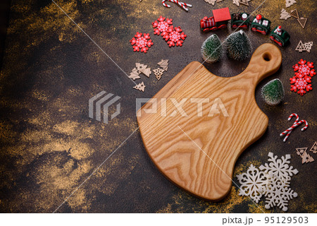 Beautiful gingerbread on a brown ceramic plate with Christmas tree decorations 95129503