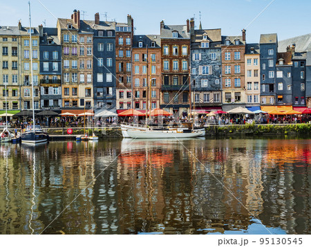 Impressive view of Honfleur waterfront with colorful houses reflected in the harbor, Normandy, France Impressive view of Honfleur waterfront with colorful houses reflected in the harbor, Normandy, France 95130545