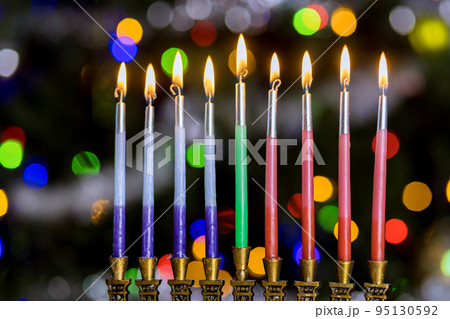 Symbol of Hanukkah Jewish holiday in Hanukkiah Menorah lit by candles in blurred bokeh lit background Symbol of Hanukkah Jewish holiday in Hanukkiah Menorah lit by candles in blurred bokeh lit background 95130592