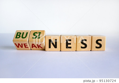 Business or weakness symbol. Turned wooden cubes and changed the word 'weakness' to 'business'. Beautiful white background, copy space. Business or weakness concept. Business or weakness symbol. Turned wooden cubes and changed the word 'weakness' to 'business'. Beautiful white background, copy space. Business or weakness concept. 95130724