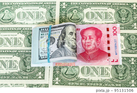 Folded american dollars banknotes wrapped by rubber band and chinese banknote 95131506