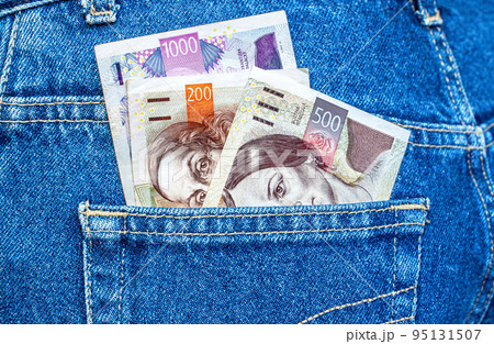 Czech crown banknotes sticking out of the jeans pocket Czech crown banknotes sticking out of the jeans pocket 95131507