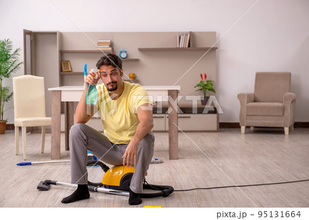 Young man doing housework at home Young man doing housework at home 95131664