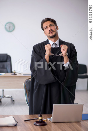 Young male judge in corruption concept Young male judge in corruption concept 95131799