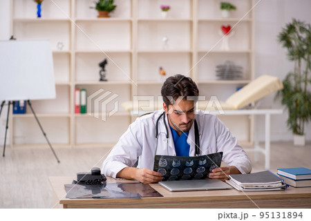 Young male doctor radiologist working in the clinic Young male doctor radiologist working in the clinic 95131894