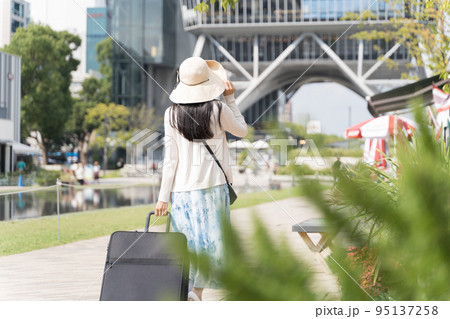 スーツケースを引いて名古屋観光をする若い女性 後ろ姿 スーツケースを引いて名古屋観光をする若い女性 後ろ姿 95137258