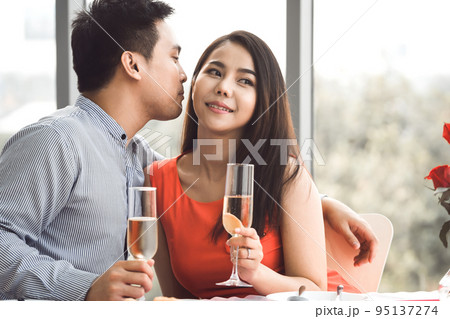 Adult asian lover couple man and woman hand hold a champagne. Adult asian lover couple man and woman hand hold a champagne. 95137274