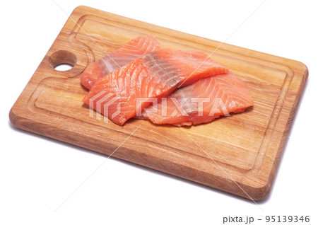 piece of salmon fillet on wooden cutting board isolated on white background 95139346