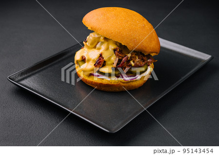 delicious burger with torn meat on black tray delicious burger with torn meat on black tray 95143454