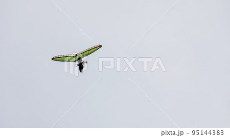 Ultralight trike flies in the sky. 95144383