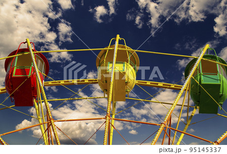 Attraction (carousel) ferris wheel against the background of a romantic evening sky 95145337