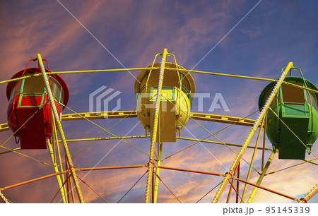 Attraction (carousel) ferris wheel against the background of a romantic evening sky 95145339