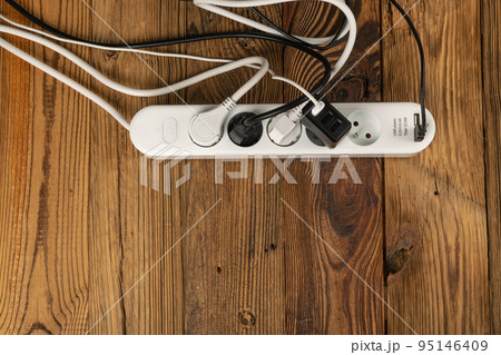 Power Strip, Extension Cable on Wooden Background Power Strip, Extension Cable on Wooden Background 95146409