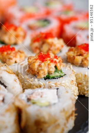 Traditional japanese sushi roll with tuna, tobiko red caviar and cucumber. Traditional japanese sushi roll with tuna, tobiko red caviar and cucumber. 95146562