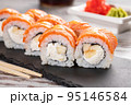 Set of Philadelphia sushi on black concrete plate on table. 95146584
