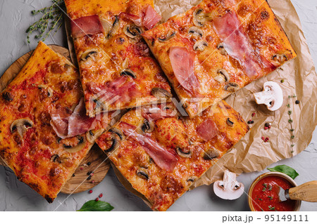 Long pizza mix lies on a wooden table Long pizza mix lies on a wooden table 95149111