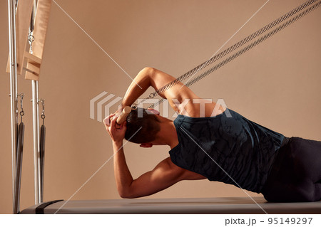 Fit man doing a lunge stretch yoga pilates exercise to strengthen