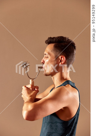 Young man testing breathing function by breath a cizer. Take care about health. Young man testing breathing function by breath a cizer. Take care about health. 95149299