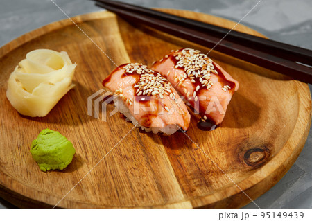 Sushi with smoked eel and sesame seeds on a black background. Japanese dish Unagi sushi. 95149439