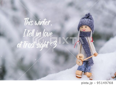 This winter, I fell in love at frost sight Inspiration joke quote phrase Angel gnome in scarf and knitted hat skiing on snowy fir branch Elf toy on skis in snowy landscape New year and Merry Christmas 95149768
