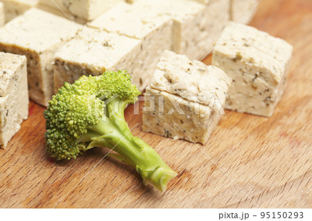 tofu cheese with broccoli on the cutting board tofu cheese with broccoli on the cutting board 95150293