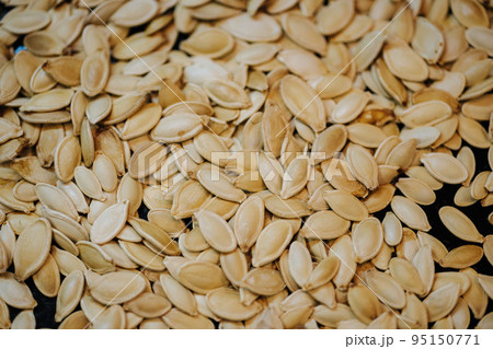 Scattered across the baking sheet roasted pumpkin seeds in shell Scattered across the baking sheet roasted pumpkin seeds in shell 95150771