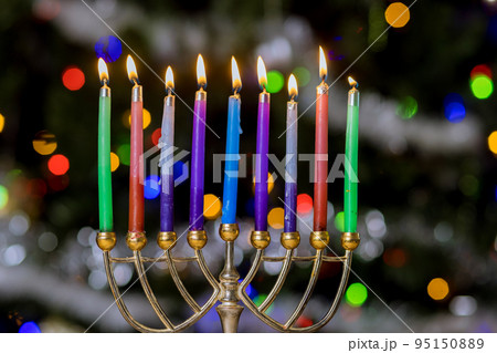 Hanukkiah Menorah with burned candles on blurred bokeh in Jewish holiday symbol for Hanukkah 95150889