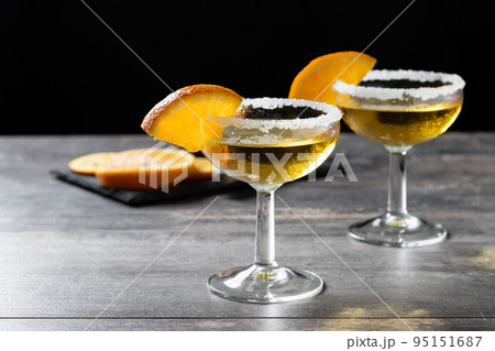 Sidecar cocktail with a sugar rim on wooden table Sidecar cocktail with a sugar rim on wooden table 95151687