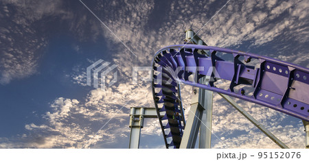 Attraction roller-coaster (switchback) against the background of a romantic evening sky 95152076