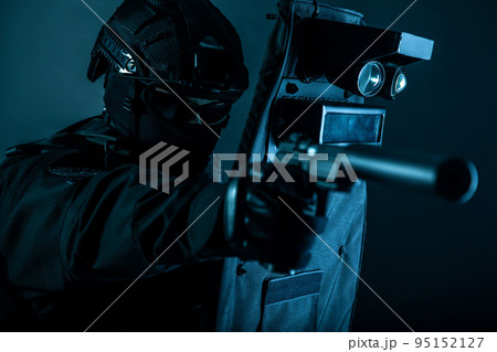 Police special forces fighter, assault team member, tactical group officer in black uniforms, aiming with silenced pistol while hiding behind, covering himself with ballistic shield, toned colorized Police special forces fighter, assault team member, tactical group officer in black uniforms, aiming with silenced pistol while hiding behind, covering himself with ballistic shield, toned colorized 95152127