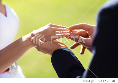 Wedding engagement rings. Married couple exchange wedding rings at a wedding ceremony. Wedding engagement rings. Married couple exchange wedding rings at a wedding ceremony. 95152136