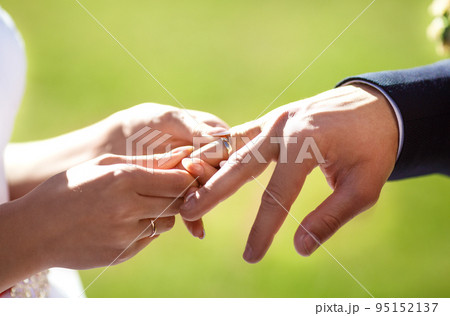 Wedding engagement rings. Married couple exchange wedding rings at a wedding ceremony. 95152137