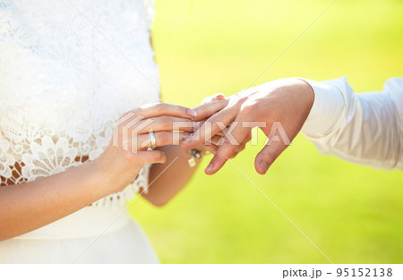 Wedding engagement rings. Married couple exchange wedding rings at a wedding ceremony. 95152138