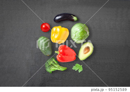 Ripe vegetables on a dark background - eggplant, sweet pepper, cabbage, avocado, tomato and sweet pepper 95152589