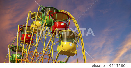 Attraction (carousel) ferris wheel against the background of a romantic evening sky Attraction (carousel) ferris wheel against the background of a romantic evening sky 95152804