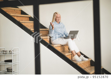 Merry mature woman communicating over the Internet 95152870
