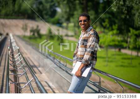 Young african american man with a laptop in the countryside 95153368