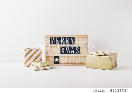 Christmas letter board spelling Merry Christmas and Happy New Year with wrapping gifts and christmas decorations. 95153554