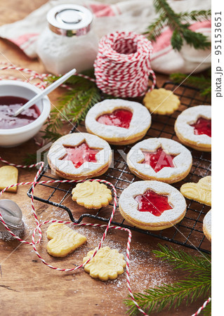 Classic Linzer Christmas Cookies with raspberry or strawberry jam on wooden table Classic Linzer Christmas Cookies with raspberry or strawberry jam on wooden table 95153651