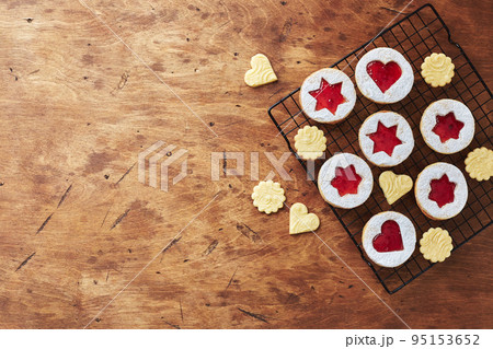 Classic Linzer Christmas Cookies with raspberry or strawberry jam on wooden table Classic Linzer Christmas Cookies with raspberry or strawberry jam on wooden table 95153652
