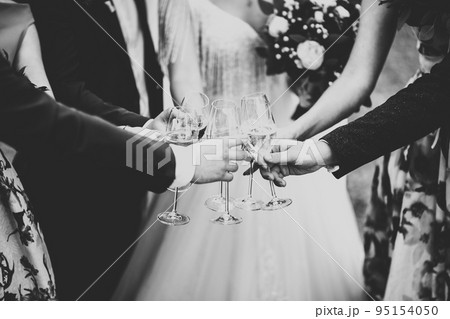 Party with friends. Group of cheerful young people carrying sparklers and champagne flutes 95154050