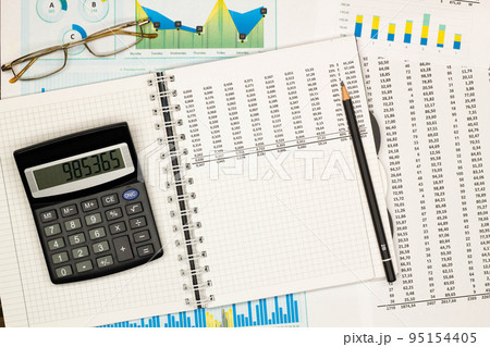 Top view office table desk. Financial report. Flat lay. Workspace with Business office supplies, numbers and empty sheet of paper, pen, glasses, calculator. Copy space for text. Top view. Close-up 95154405